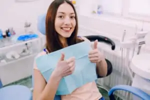 happy young healthy woman treated teeth